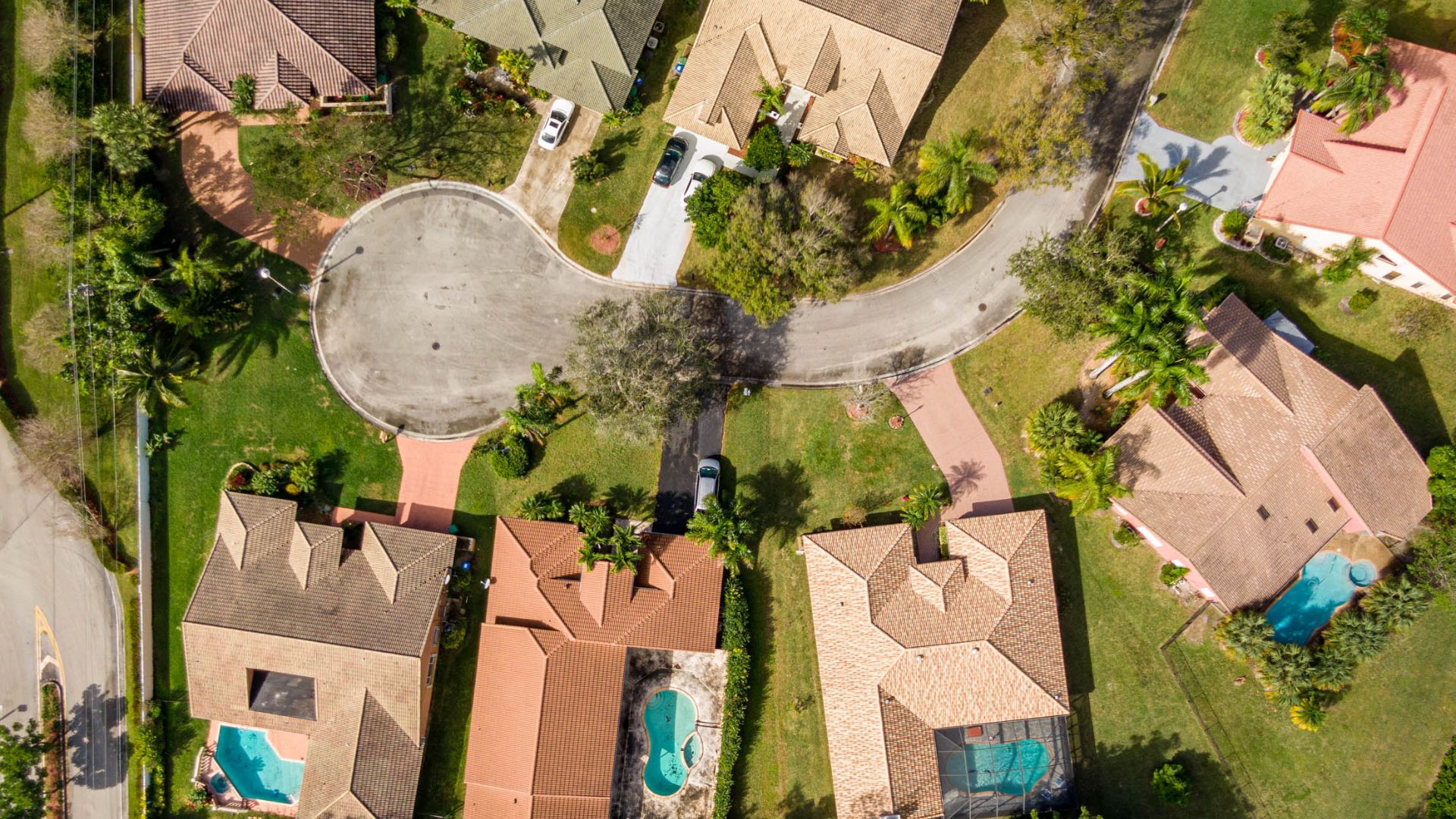 Aerial drone photo of an Emerald Coast residential neighborhood with pools