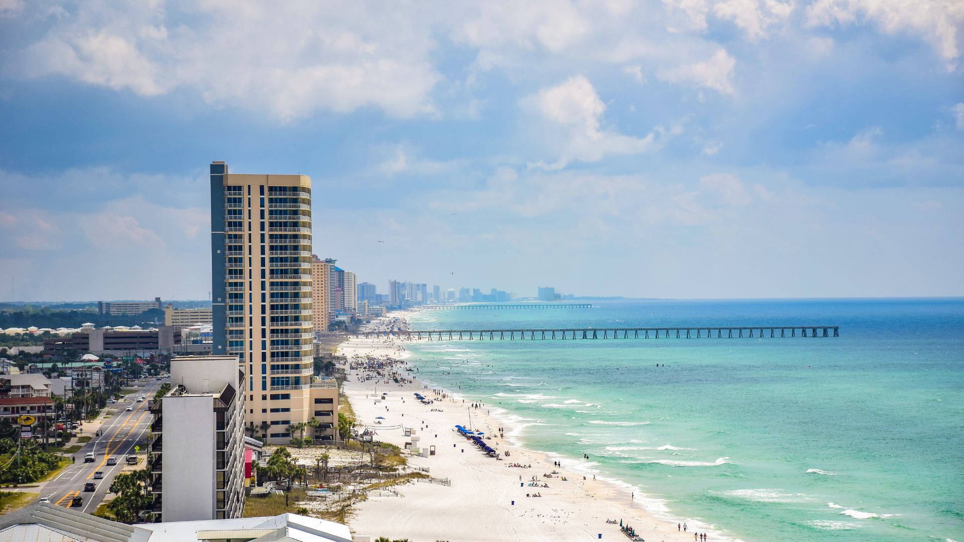 Cinematic aerial view of the Emerald Coast shoreline and turquoise Gulf water